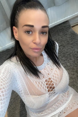 Busty mixed race English girl in a white dress