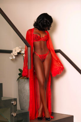 Slim elegant ebony girl in a sexy red dress