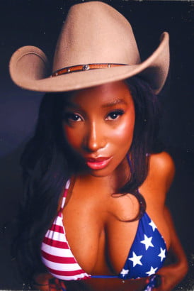 Petite black girl in a cowboy's hat and an American flag bikini